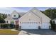 Charming home features a 2-car garage, manicured lawn, and inviting curb appeal at 1201 Ficus Dr., Myrtle Beach, SC 29579