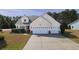 A well maintained home with a spacious driveway, two-car garage, and landscaped front yard at 1201 Ficus Dr., Myrtle Beach, SC 29579