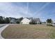 Back view of home with an expansive lawn and view of neighborhood and tree line at 1201 Ficus Dr., Myrtle Beach, SC 29579