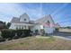 Charming home featuring an American flag, lush landscaping, and inviting front porch with seating area at 1201 Ficus Dr., Myrtle Beach, SC 29579