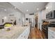Gourmet kitchen featuring stainless steel appliances, granite countertops, pantry, and hardwood floors at 1201 Ficus Dr., Myrtle Beach, SC 29579