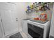 Well-equipped laundry room with modern washer and dryer, storage shelves, and access to an exterior door at 1201 Ficus Dr., Myrtle Beach, SC 29579
