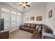 Bright living room featuring a leather sofa, large windows, and natural light, perfect for relaxing or entertaining guests at 1201 Ficus Dr., Myrtle Beach, SC 29579