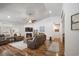 Spacious living room with fireplace, ceiling fan, hardwood floors, and comfortable seating for a relaxing and welcoming atmosphere at 1201 Ficus Dr., Myrtle Beach, SC 29579