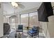 Relaxing screened-in porch with comfortable seating, ceiling fan, and views of backyard at 1201 Ficus Dr., Myrtle Beach, SC 29579