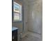 Bathroom featuring a marble tile shower and a modern window for natural light at 1217 Bentcreek Ln., Myrtle Beach, SC 29579