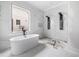 Modern bathroom with white tub, black hardware and floor to ceiling tile with window for natural light at 1217 Bentcreek Ln., Myrtle Beach, SC 29579