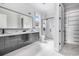 Modern bathroom features double vanity, walk-in glass shower, and large format tile flooring and walls at 1217 Bentcreek Ln., Myrtle Beach, SC 29579