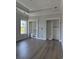 Bright bedroom featuring tray ceilings, built-in shelving, and wood-look floors at 1217 Bentcreek Ln., Myrtle Beach, SC 29579