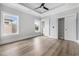 Bright bedroom with a tray ceiling, wood floor, two windows, and closets at 1217 Bentcreek Ln., Myrtle Beach, SC 29579