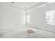 Minimalist bedroom with decorative wall, bright windows, and tray ceiling, awaiting finishing touches and personalization at 1217 Bentcreek Ln., Myrtle Beach, SC 29579