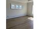 A bright bedroom featuring multiple windows and wood-look floors at 1217 Bentcreek Ln., Myrtle Beach, SC 29579