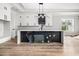 Modern kitchen with a large island, pendant lighting, and sleek black and white cabinetry at 1217 Bentcreek Ln., Myrtle Beach, SC 29579