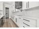 Modern kitchen with sleek white cabinets, marble countertops, and stainless steel appliances, offering a stylish design at 1217 Bentcreek Ln., Myrtle Beach, SC 29579