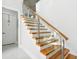 Modern stairway with wooden steps and glass railing, enhancing architectural design at 1217 Bentcreek Ln., Myrtle Beach, SC 29579