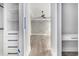 View from closet to the bedroom featuring decorative wall, tray ceilings, modern ceiling fan and hardwood floors at 1217 Bentcreek Ln., Myrtle Beach, SC 29579