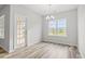 Bright dining room featuring luxury vinyl floors, a chandelier, and a large window overlooking the pond at 1221 Cypress Shoal Dr., Conway, SC 29526