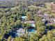 A beautiful aerial view showcases tennis courts, pools, and houses in a lush, green community at 1221 Tidewater Dr. # 1721, North Myrtle Beach, SC 29582