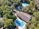 An aerial view reveals a pool, clubhouse, and outdoor amenities surrounded by verdant trees at 1221 Tidewater Dr. # 1721, North Myrtle Beach, SC 29582