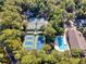 Aerial view of tennis courts and pool nestled among lush trees in a beautiful community at 1221 Tidewater Dr. # 1721, North Myrtle Beach, SC 29582