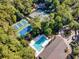 Aerial view of community tennis courts and pool, surrounded by lush foliage, showcasing recreational amenities at 1221 Tidewater Dr. # 1721, North Myrtle Beach, SC 29582