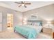 Inviting bedroom with neutral tones, a ceiling fan, and an adjacent bathroom, creating a relaxing retreat at 1221 Tidewater Dr. # 1721, North Myrtle Beach, SC 29582