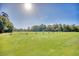 Spacious driving range with multiple teeing areas, set against a backdrop of lush trees and clear blue skies at 1221 Tidewater Dr. # 1721, North Myrtle Beach, SC 29582