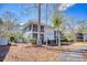 Charming two-story building with a screened-in porch, nestled among mature trees in a serene setting at 1221 Tidewater Dr. # 1721, North Myrtle Beach, SC 29582