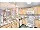 Well-lit kitchen featuring granite countertops and essential appliances for a functional cooking space at 1221 Tidewater Dr. # 1721, North Myrtle Beach, SC 29582