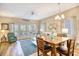 Bright living room with a dining table, hardwood floors, and access to the outdoor balcony at 1221 Tidewater Dr. # 1721, North Myrtle Beach, SC 29582