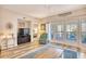 Cozy living room with a TV and balcony access that brings in ample natural light at 1221 Tidewater Dr. # 1721, North Myrtle Beach, SC 29582