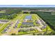 Expansive aerial view showcasing a new community with ponds, green spaces, and modern homes amidst a wooded landscape at 1227 Cypress Shoal Dr., Conway, SC 29526