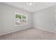 Bright bedroom with neutral walls, carpet, and a large window offering natural light at 1227 Cypress Shoal Dr., Conway, SC 29526