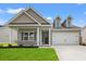 Charming home featuring manicured lawn, inviting entrance, and two-car garage at 1227 Cypress Shoal Dr., Conway, SC 29526
