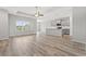 Open-concept living space featuring hardwood floors and large windows offering natural light at 1227 Cypress Shoal Dr., Conway, SC 29526