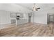 Bright living area open to the kitchen, complete with hardwood floors and modern lighting at 1227 Cypress Shoal Dr., Conway, SC 29526