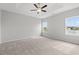 Spacious primary bedroom filled with natural light from two windows and a ceiling fan at 1227 Cypress Shoal Dr., Conway, SC 29526