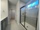 Bright bathroom features a glass shower and leads to the walk-in closet at 1229 Lady Bird Way, North Myrtle Beach, SC 29582