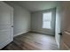 Neutral bedroom with hardwood floors, a white door, and a window at 1229 Lady Bird Way, North Myrtle Beach, SC 29582