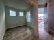 Inviting entryway with hardwood floors and two windows; front door open at 1229 Lady Bird Way, North Myrtle Beach, SC 29582