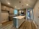 A spacious kitchen featuring gray cabinets, a large center island, and stainless steel appliances at 1229 Lady Bird Way, North Myrtle Beach, SC 29582