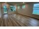 Bright living room with hardwood floors and lots of natural light from multiple windows and glass doors at 1229 Lady Bird Way, North Myrtle Beach, SC 29582