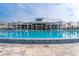 Large outdoor pool and entertainment area featuring lounge chairs and palm trees at 1229 Lady Bird Way, North Myrtle Beach, SC 29582