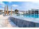 Luxury outdoor pool with water features, lounge chairs, and palm trees under a sunny sky at 1229 Lady Bird Way, North Myrtle Beach, SC 29582