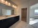 Bathroom with double vanity, white countertop, and marble floors at 1249 Crested Iris Way, North Myrtle Beach, SC 29582