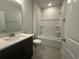 Well-lit bathroom featuring a tub and shower combination, vanity and lavatory at 1249 Crested Iris Way, North Myrtle Beach, SC 29582