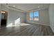 Bedroom with hardwood floors, natural light, and ensuite bathroom at 1249 Crested Iris Way, North Myrtle Beach, SC 29582