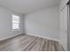 Bedroom with light gray walls, wood-look flooring, and a window at 1249 Crested Iris Way, North Myrtle Beach, SC 29582