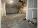 Spacious unfinished garage, featuring a roll-up garage door and an attic access ladder at 1249 Crested Iris Way, North Myrtle Beach, SC 29582