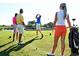 Golfers enjoying a sunny day on the golf course surrounded by lush greenery at 1249 Crested Iris Way, North Myrtle Beach, SC 29582